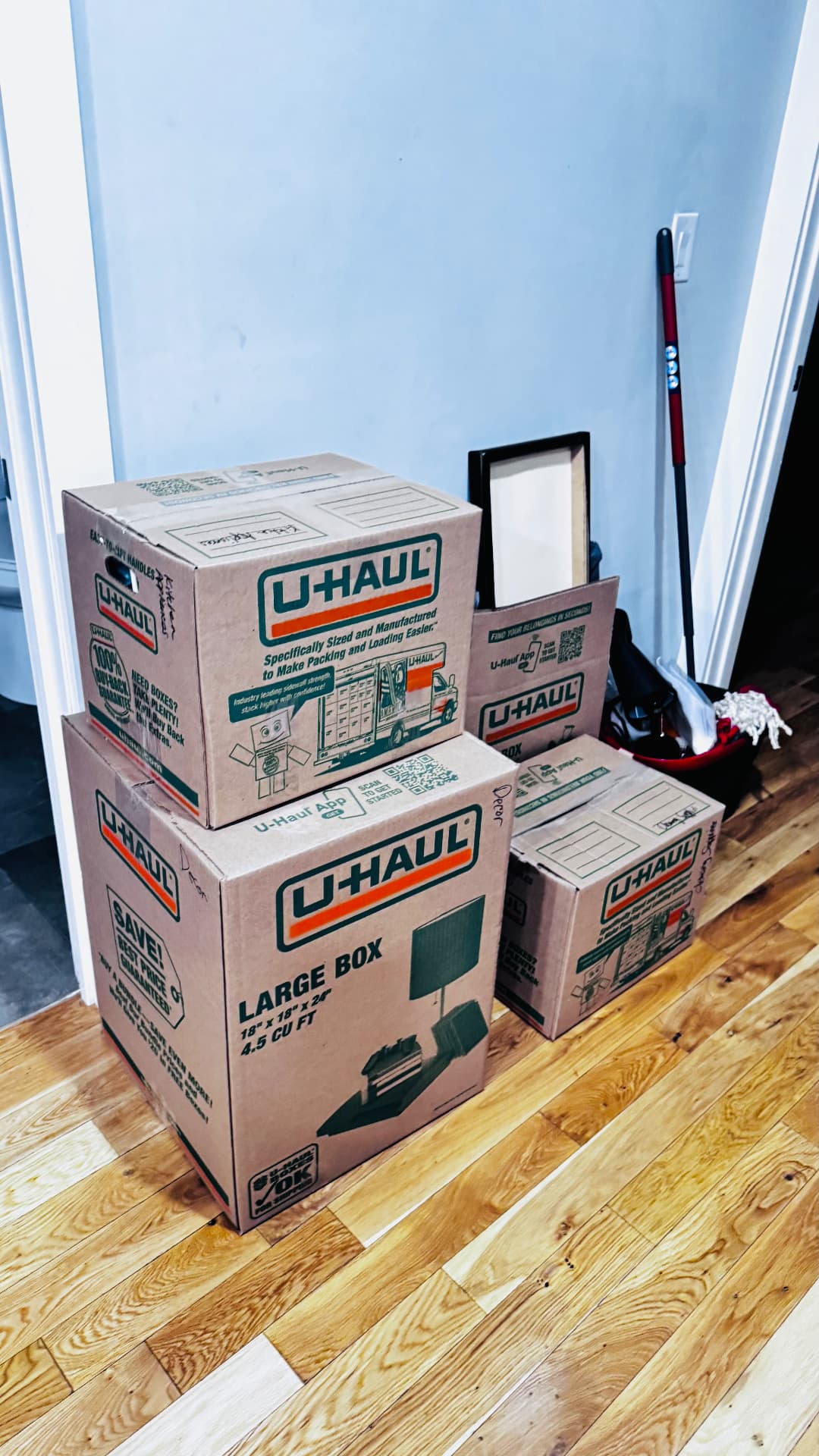 Neatly stacked labeled moving boxes ready for transport